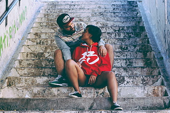 Couple sitting on urban stairs sharing an intimate moment