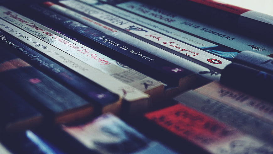 Stack of paperback novels with blurred background