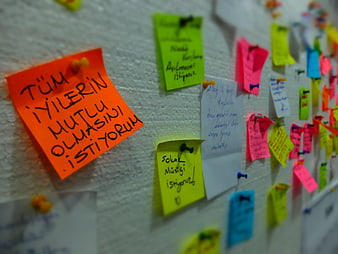 Colorful Sticky Notes With Handwritten Wishes Pinned To Corkboard