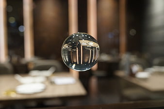 Crystal sphere reflecting restaurant interior with blurred background
