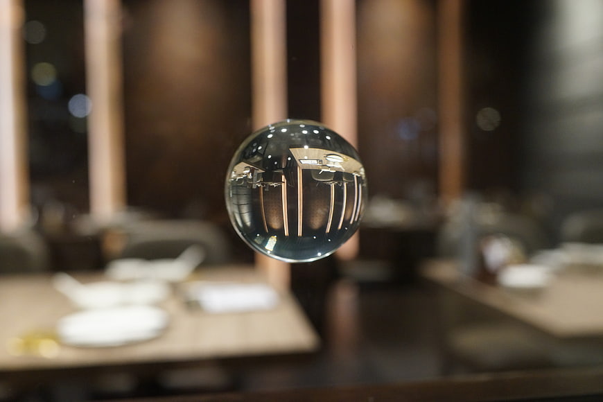Crystal sphere reflecting restaurant interior with blurred background