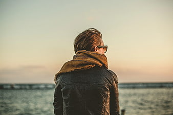 Man in Leather Jacket and Scarf Looking at Sunset