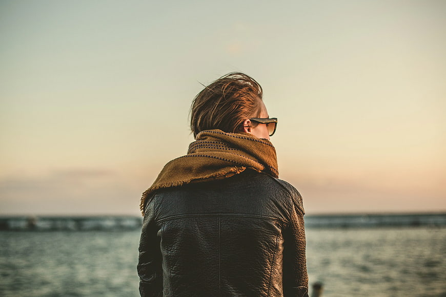 Man in Leather Jacket and Scarf Looking at Sunset
