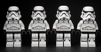 Four Identical Lego Stormtrooper Minifigures Standing in a Row
