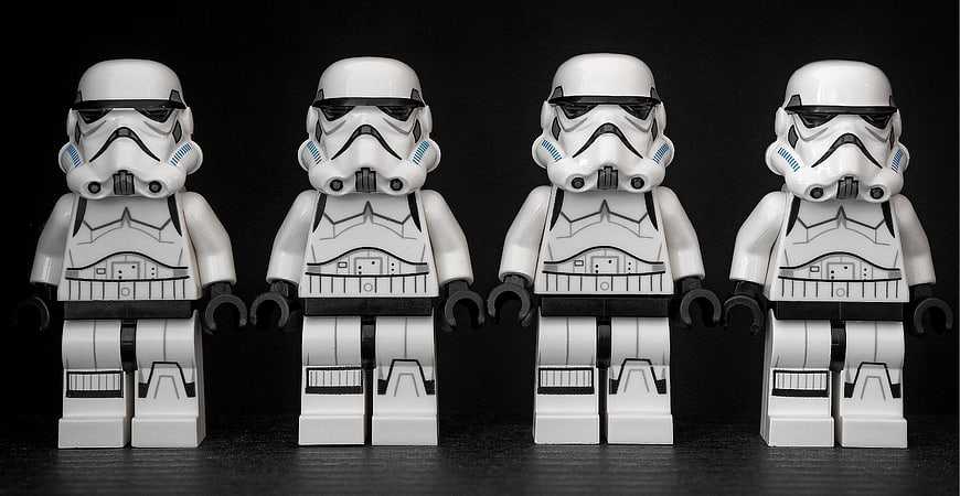 Four Identical Lego Stormtrooper Minifigures Standing in a Row