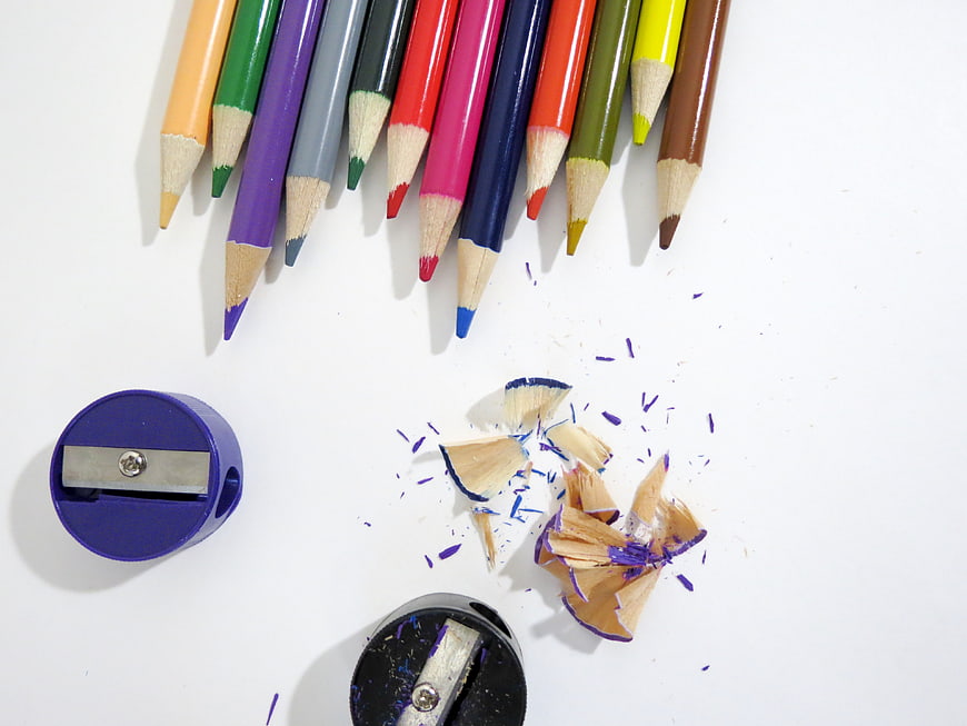 Colorful pencils and sharpeners on white background
