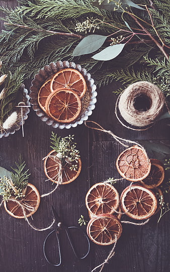 Rustic DIY Christmas ornaments with dried orange slices and greenery
