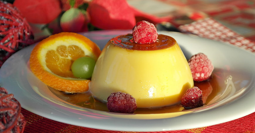 Creamy Caramel Pudding with Raspberries and Orange Slice