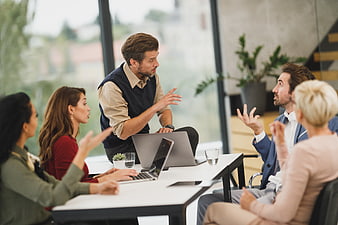 Diverse business team discussing strategy in modern office meeting