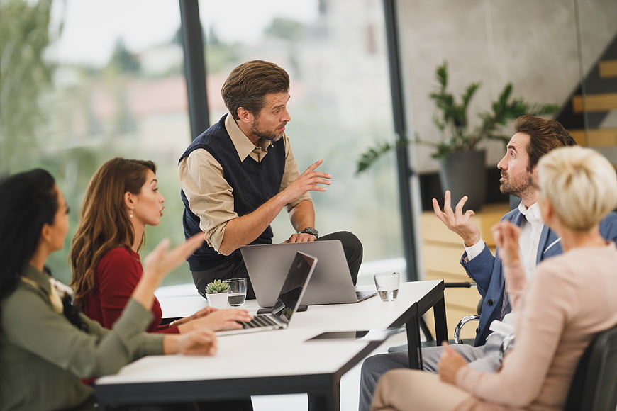 Diverse business team discussing strategy in modern office meeting