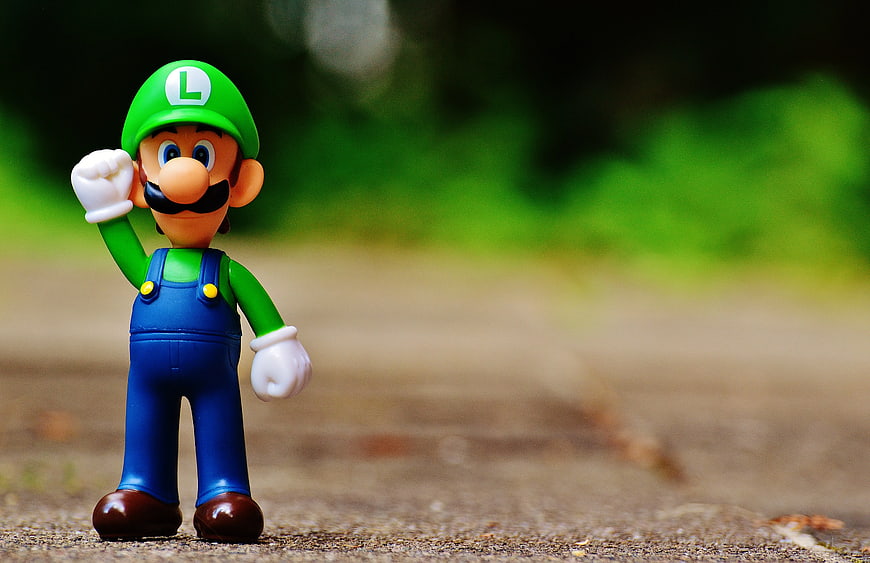 Luigi Action Figure Toy on Outdoor Path