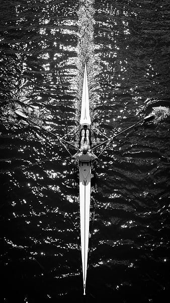 Aerial black and white view of a rower on sparkling water