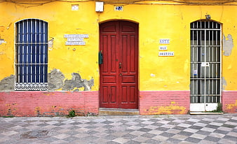 Vibrant Yellow And Red Spanish Street Facade In Seville