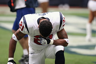 NFL Football Player Kneeling in Prayer on Field