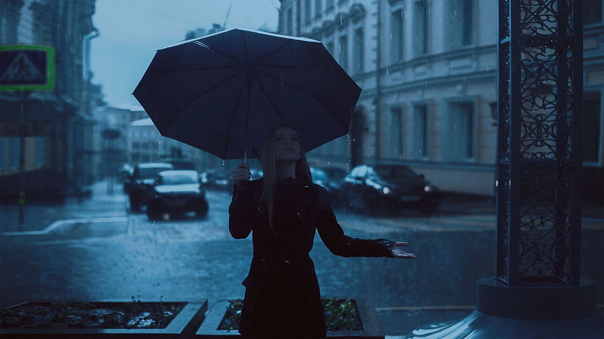 Woman with Umbrella in Rainy City Street