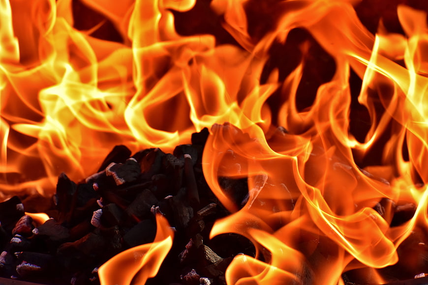 Close-up of burning charcoal with bright orange flames
