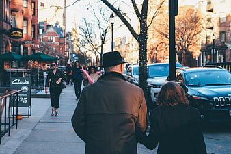 Couple walking down city street in winter afternoon