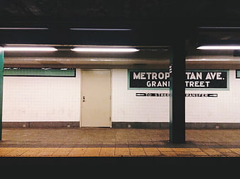 Empty Metropolitan Avenue subway station platform at night