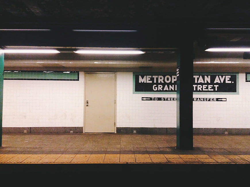 Empty Metropolitan Avenue subway station platform at night