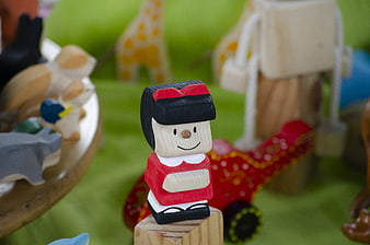 Wooden Mafalda Toy Figure on Green Background