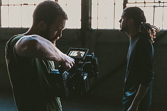 Cinematographer Filming Actor in Industrial Loft