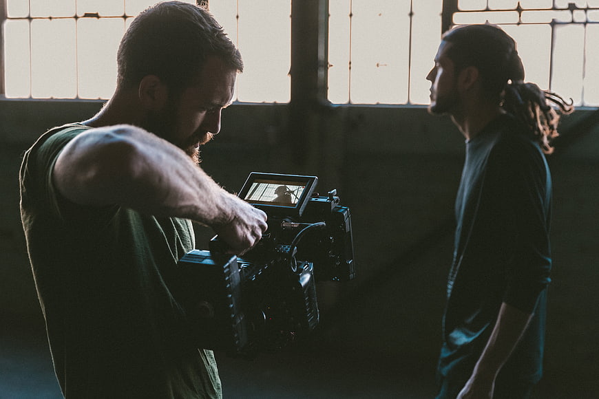 Cinematographer Filming Actor in Industrial Loft
