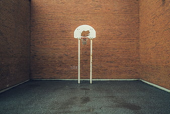 Empty Basketball Hoop Against Red Brick Wall