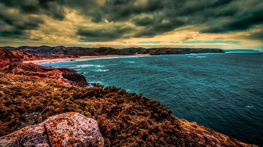 Dramatic Coastal Landscape with Stormy Sky and Turquoise Ocean