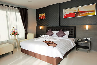 Modern Hotel Bedroom with Decorative Swans and Abstract Art