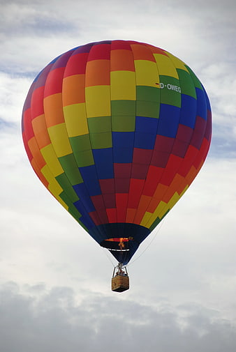Colorful Hot Air Balloon Flying in Cloudy Sky