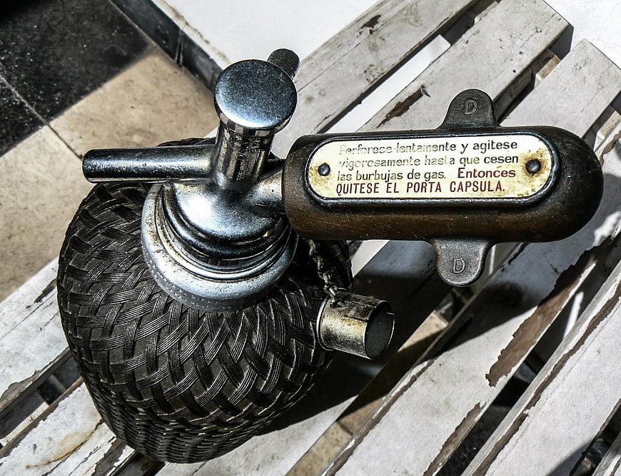 Vintage Siphon Soda Bottle on Wooden Bench