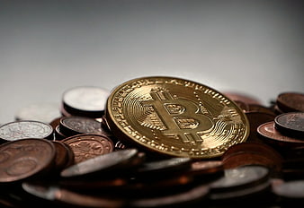 Gold Bitcoin Coin on Pile of Euro Coins
