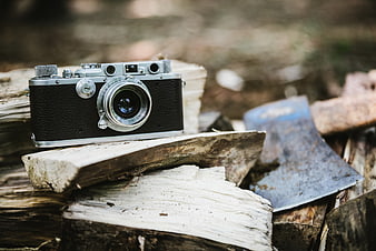 Vintage Camera on Firewood with Axe