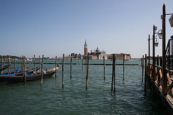 Gondolas docked in Venice lagoon with San Giorgio Maggiore