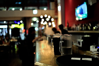 Moody Bar Interior With Blurred Background And Glass Pitcher