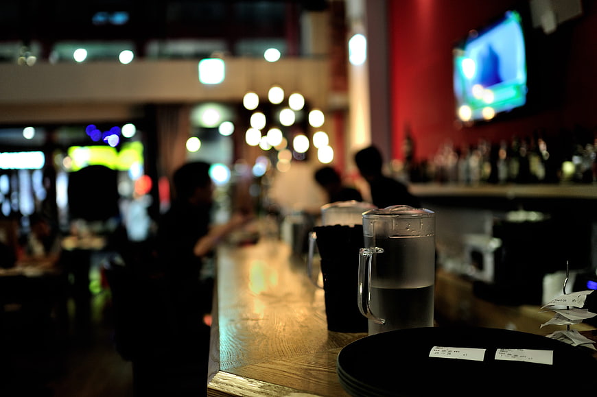 Moody Bar Interior With Blurred Background And Glass Pitcher