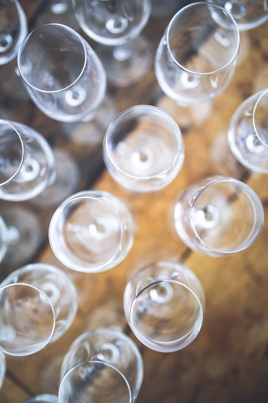 Top view of empty wine glasses on wooden table