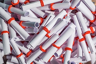 Pile of white rolled paper tickets tied with red rubber bands