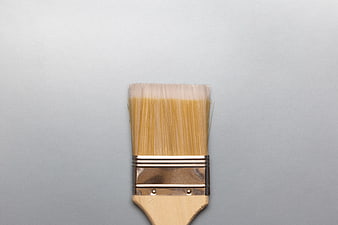 Close-up of wooden paintbrush on gray background