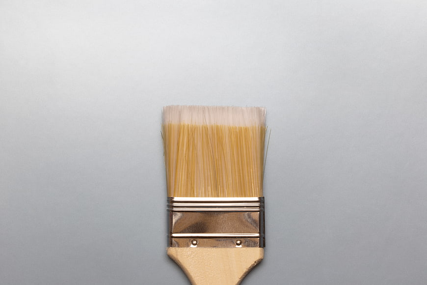 Close-up of wooden paintbrush on gray background