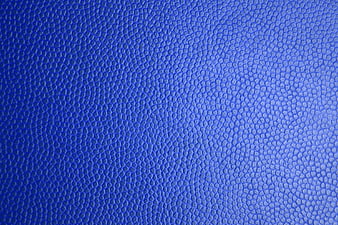 Blue textured leather surface close-up background