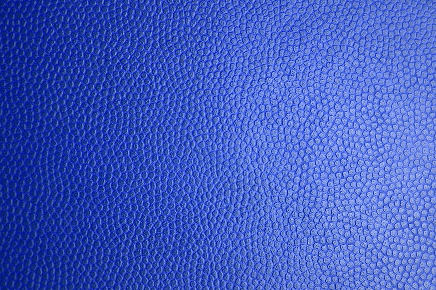 Blue textured leather surface close-up background