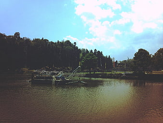Floating work platform on a calm lake with trees