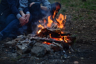Couple Sitting by Campfire at Twilight