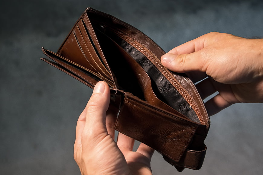 Hands Holding Open Empty Brown Leather Wallet