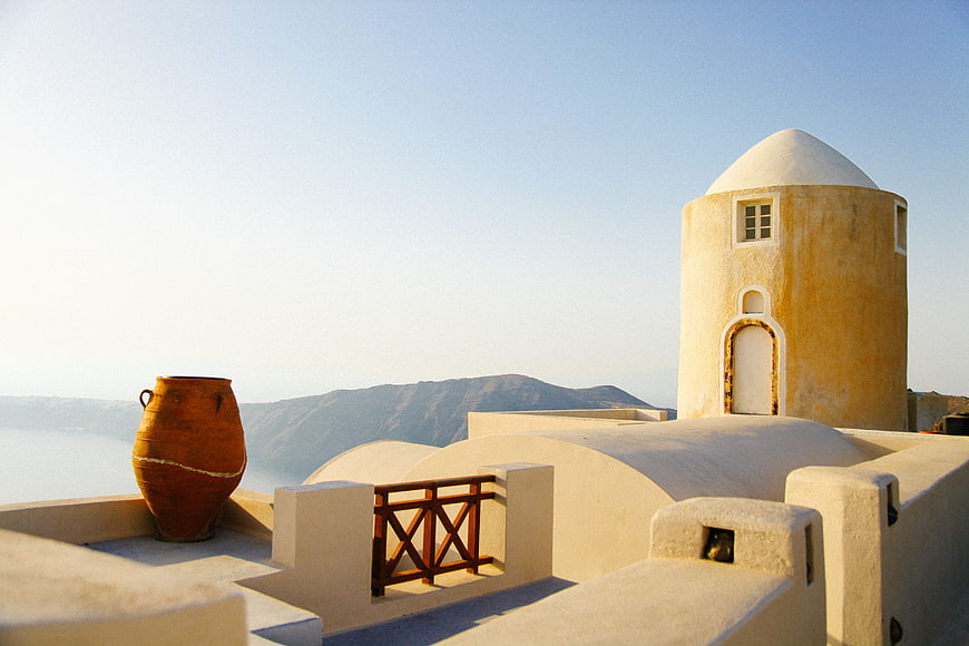 Traditional Cycladic windmill and pottery on Santorini terrace