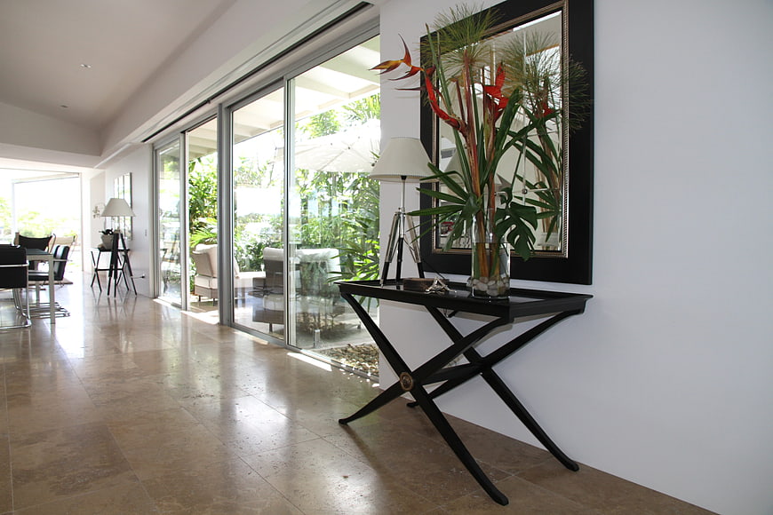 Modern luxury hallway with glass doors and tropical plants