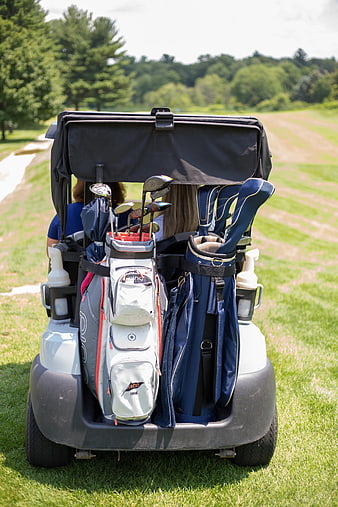 Golf Cart with Bags and Clubs on Green Course