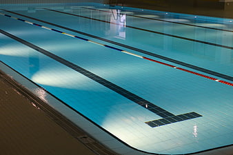 Empty Indoor Swimming Pool With Lanes And Blue Water