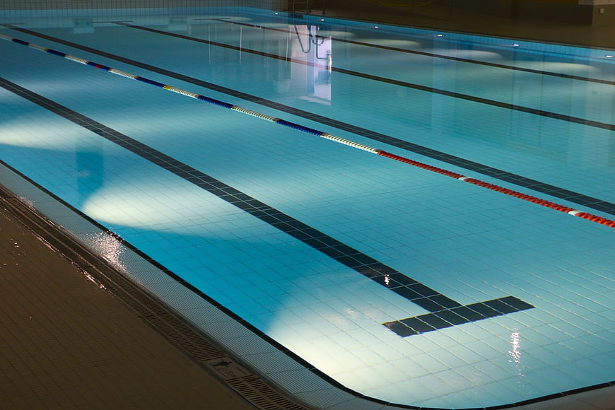 Empty Indoor Swimming Pool With Lanes And Blue Water